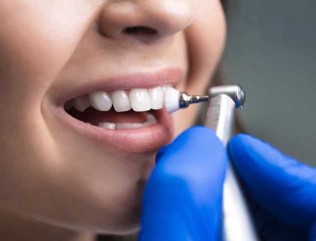 Patient receiving dental examination with blue-gloved dentist using professional tool during checkup.
