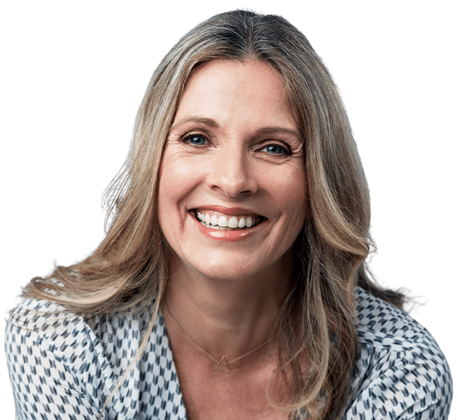 Professional headshot of smiling woman in blue patterned top against white background
