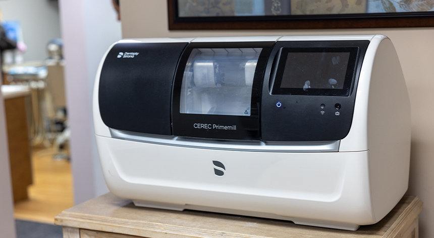 Fully automated dental laboratory analyzer machine on white countertop in clinical setting.